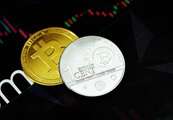 gold round coin on black surface