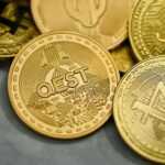 a pile of gold bitcoins sitting on top of each other