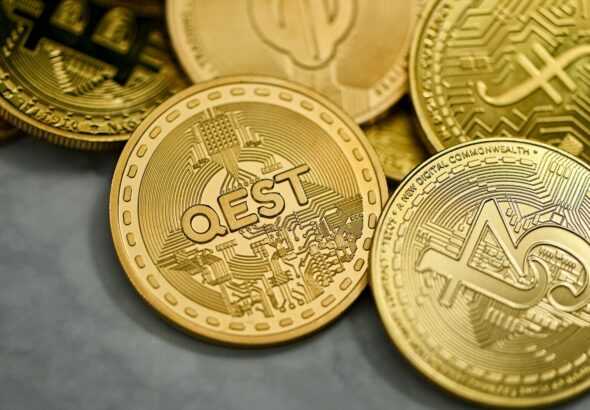 a pile of gold bitcoins sitting on top of each other