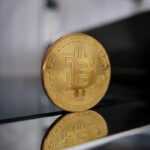 a gold bit coin sitting on top of a table