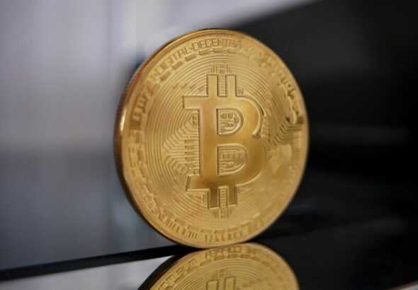a gold bit coin sitting on top of a table