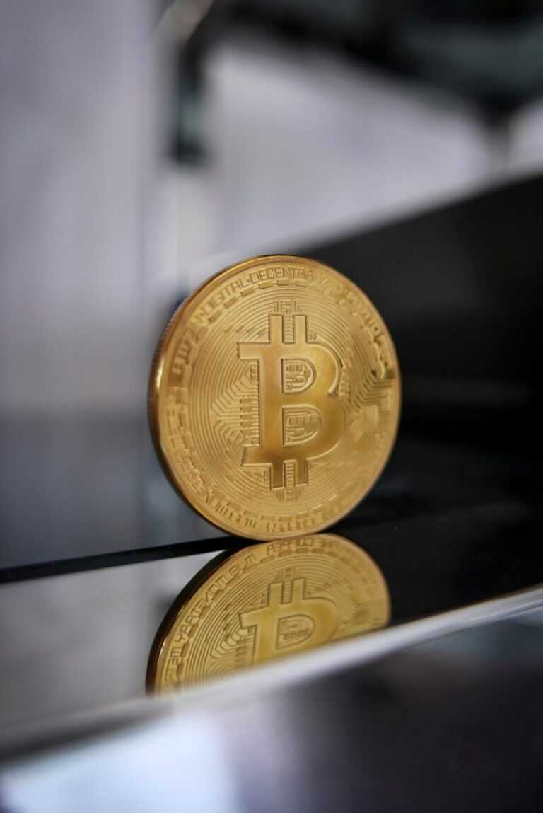 a gold bit coin sitting on top of a table