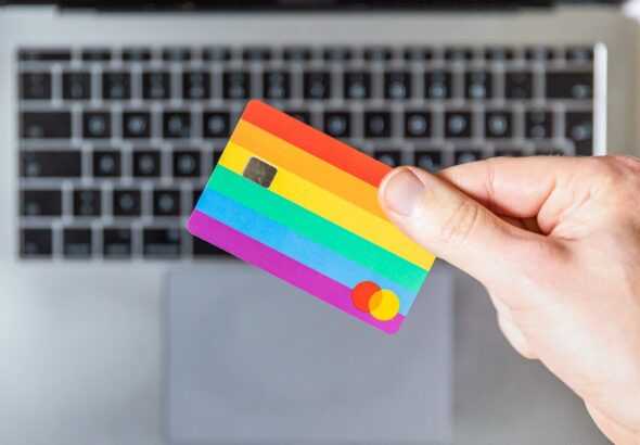 person holding yellow and pink card