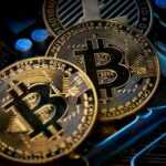 three bitcoins sitting on top of a computer motherboard