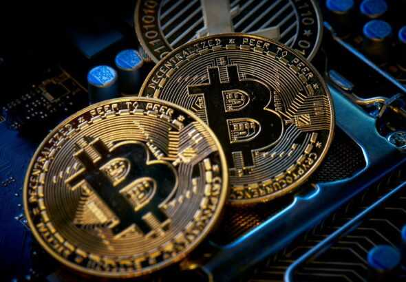 three bitcoins sitting on top of a computer motherboard