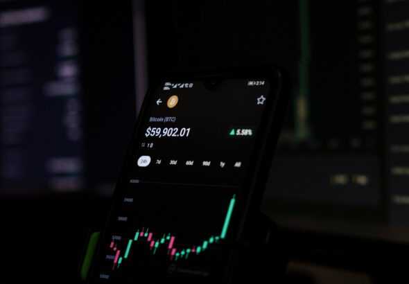 a cell phone displaying a stock chart on the screen