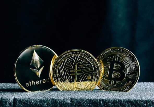 three bitcoins sitting on top of a table