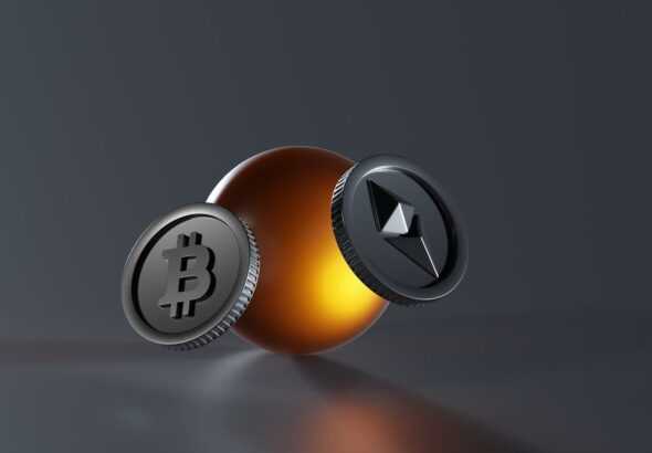 a bitcoin and a lite up coin on a table